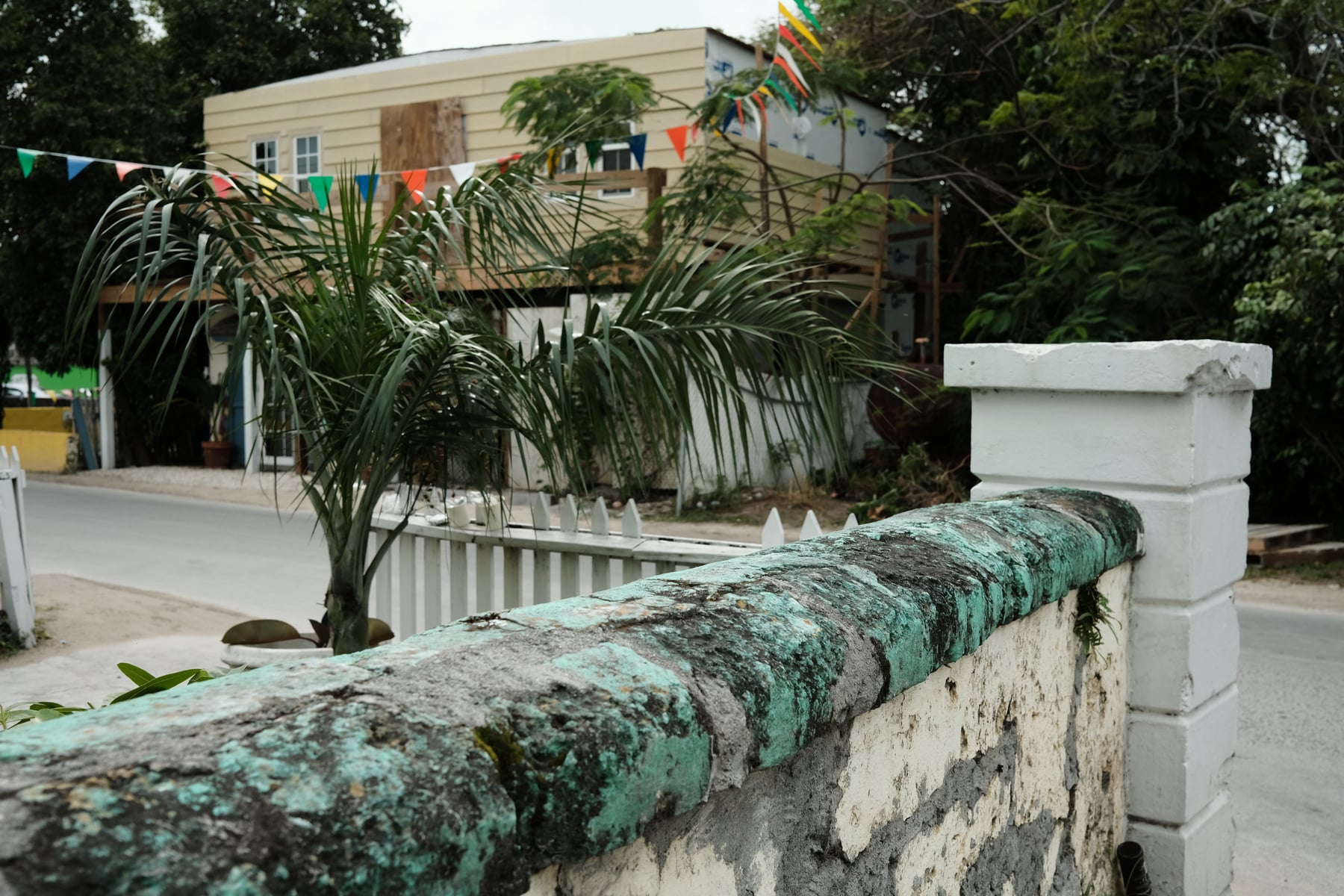 Weathered stone wall with thick patina of teal and blue-green oxidation